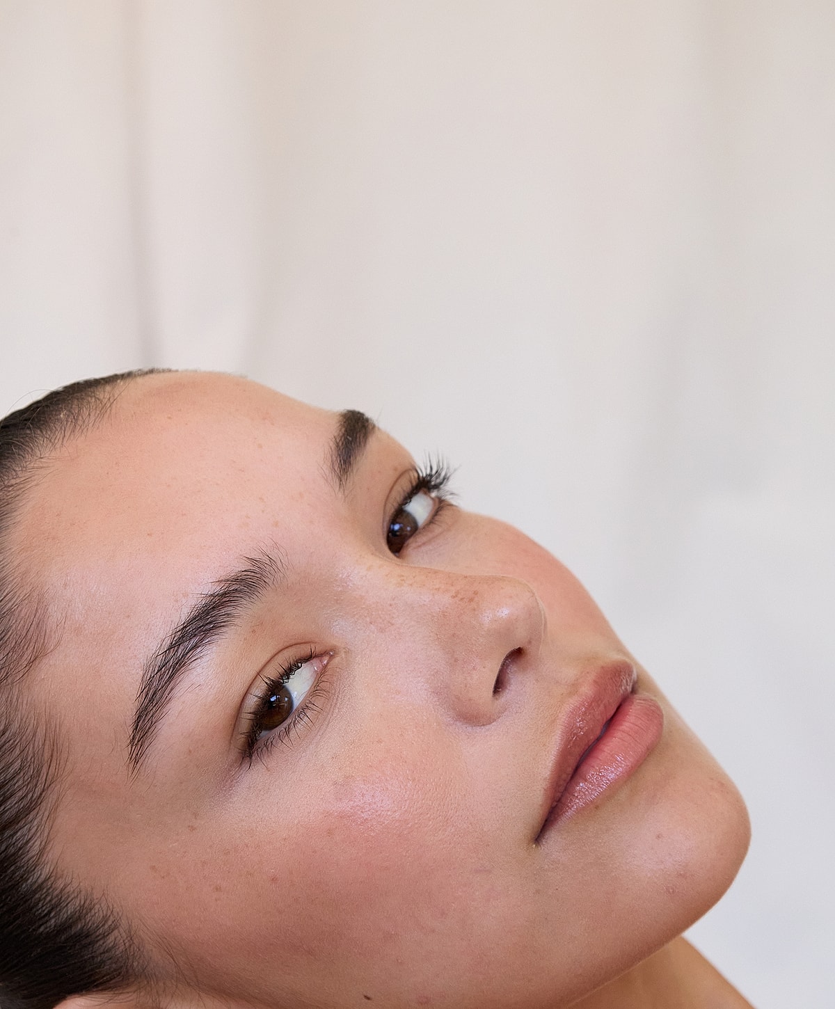 Close-up of a woman's face with freckles.