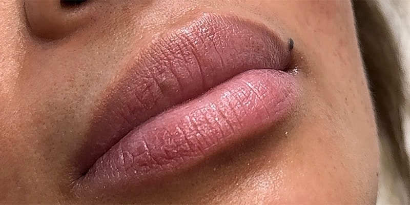 Close-up of smooth pink lips.