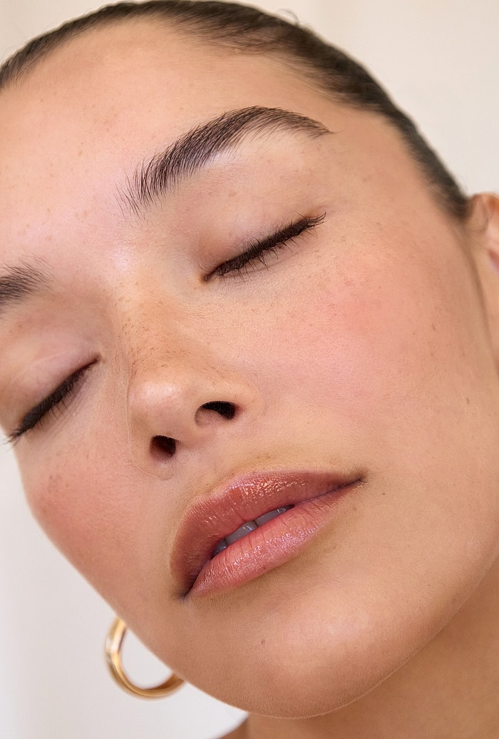 Close-up of serene woman with natural makeup.