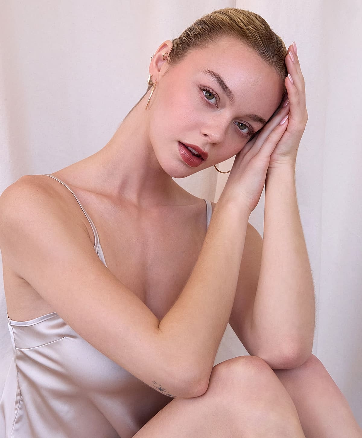 Model posing elegantly with serene expression.